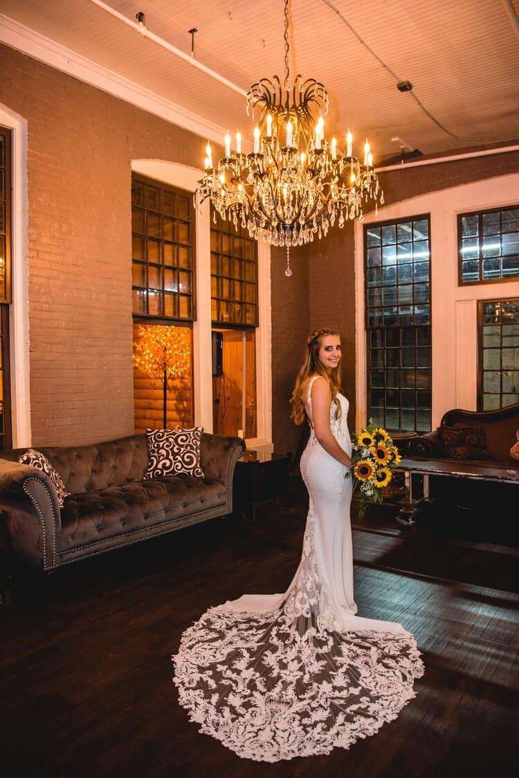 A girl in a dress under a chandelier